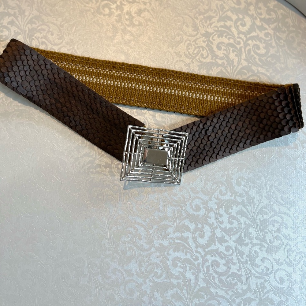 Stretchy brown belt with silver buckle. adapts to your body's movements.